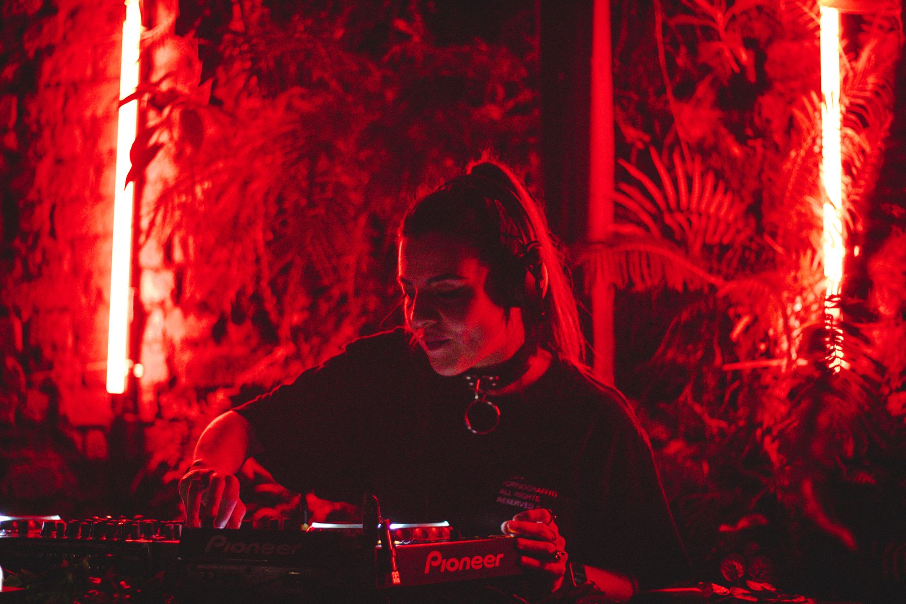 DJ performing behind a nightclub console