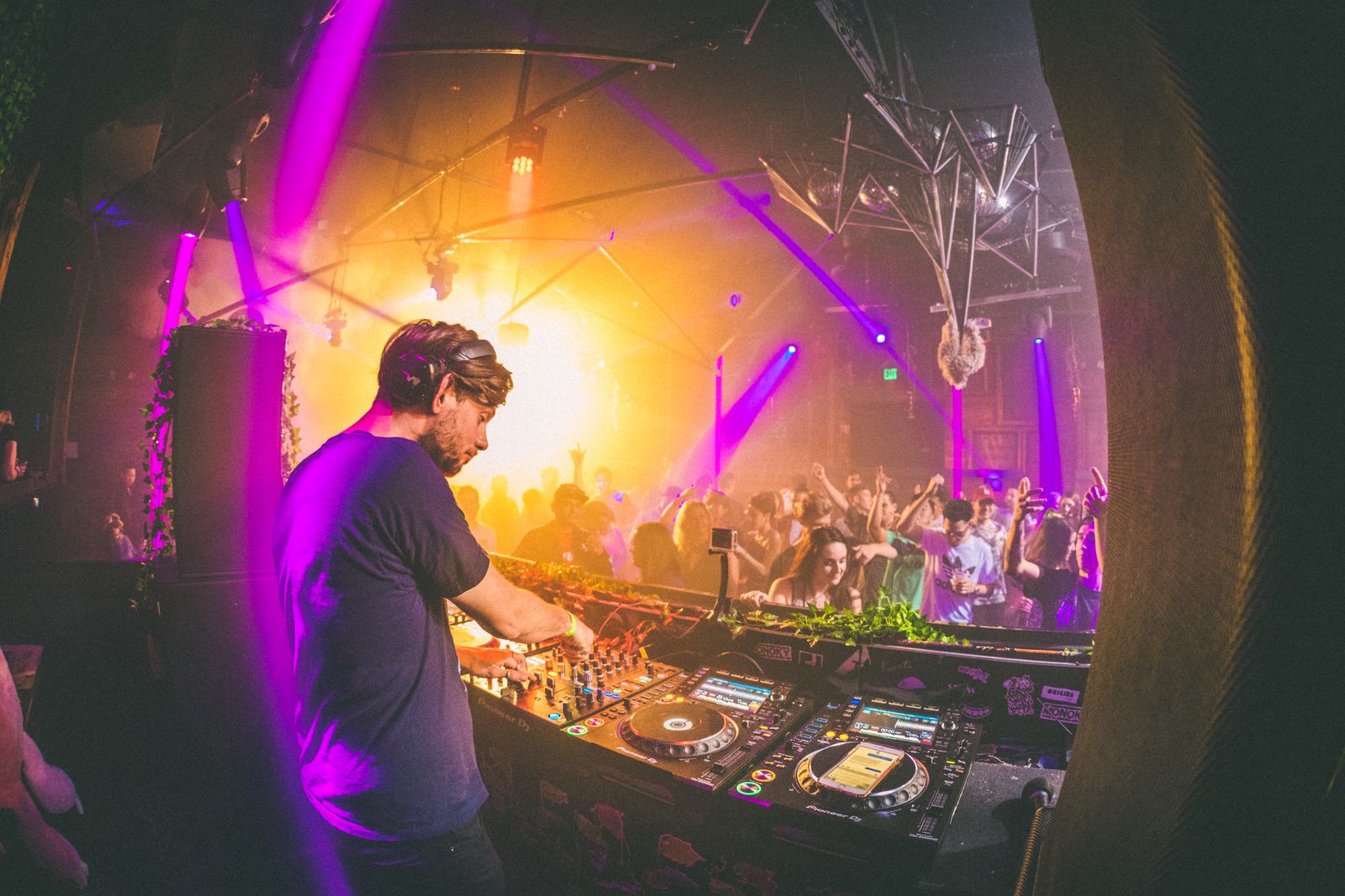 DJ performing to a crowd inside a nightclub