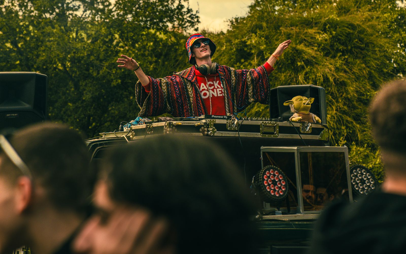 DJ performing to a festival crowd after dark