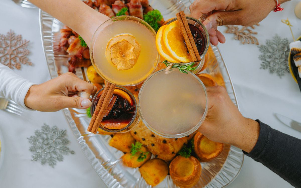Guests raising glasses over a festive dinner table