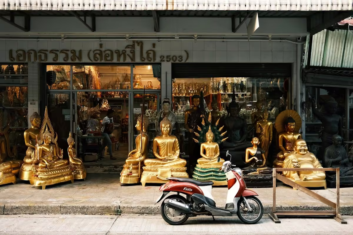 A red scooter parked on a Thai street
