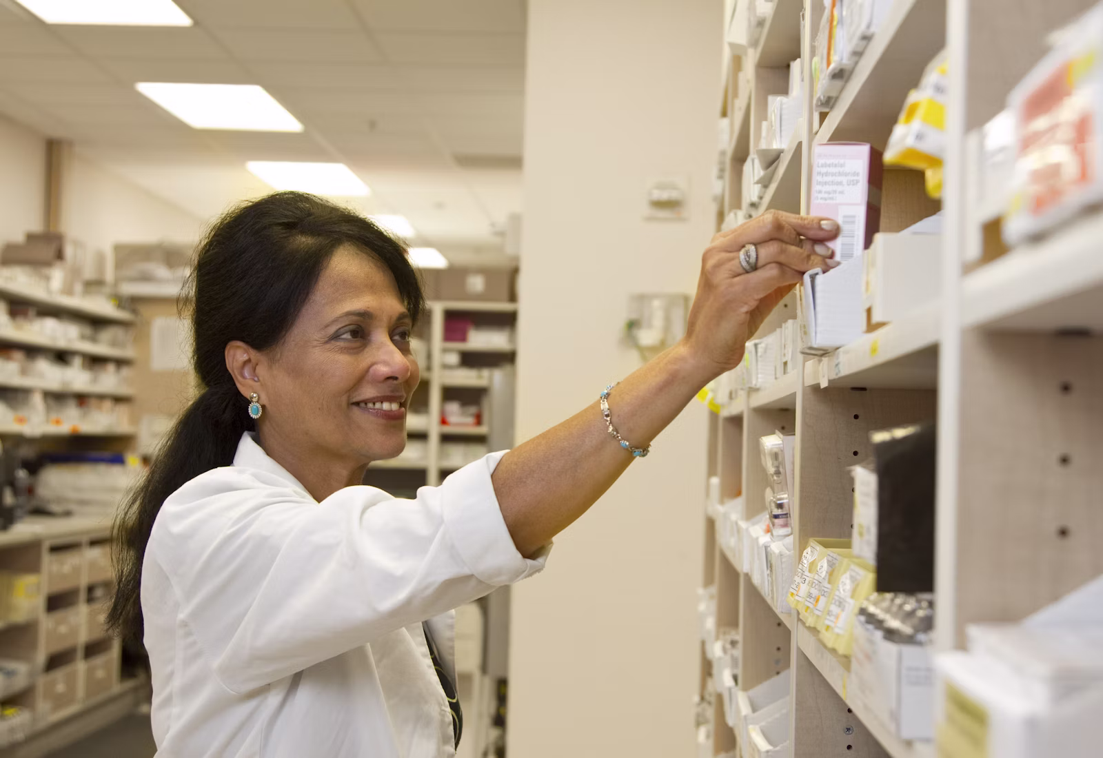 A pharmacist handing over medication