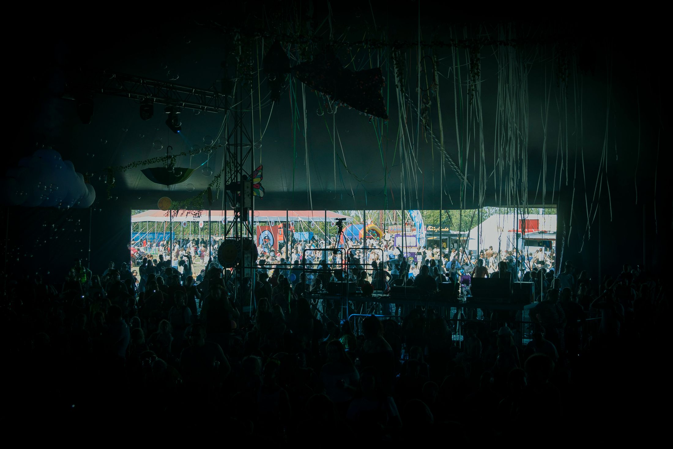A crowd gathered inside a large live music festival venue