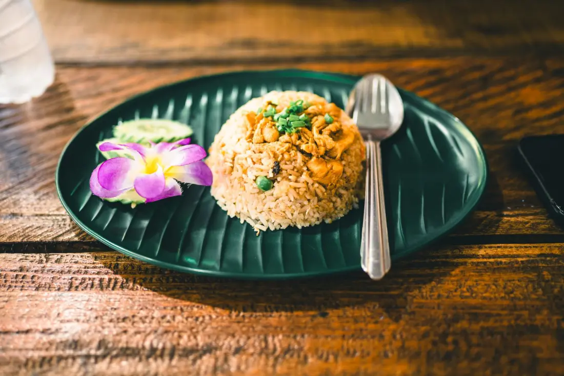 Thai fried rice served with fresh herbs and traditional garnish in Phuket