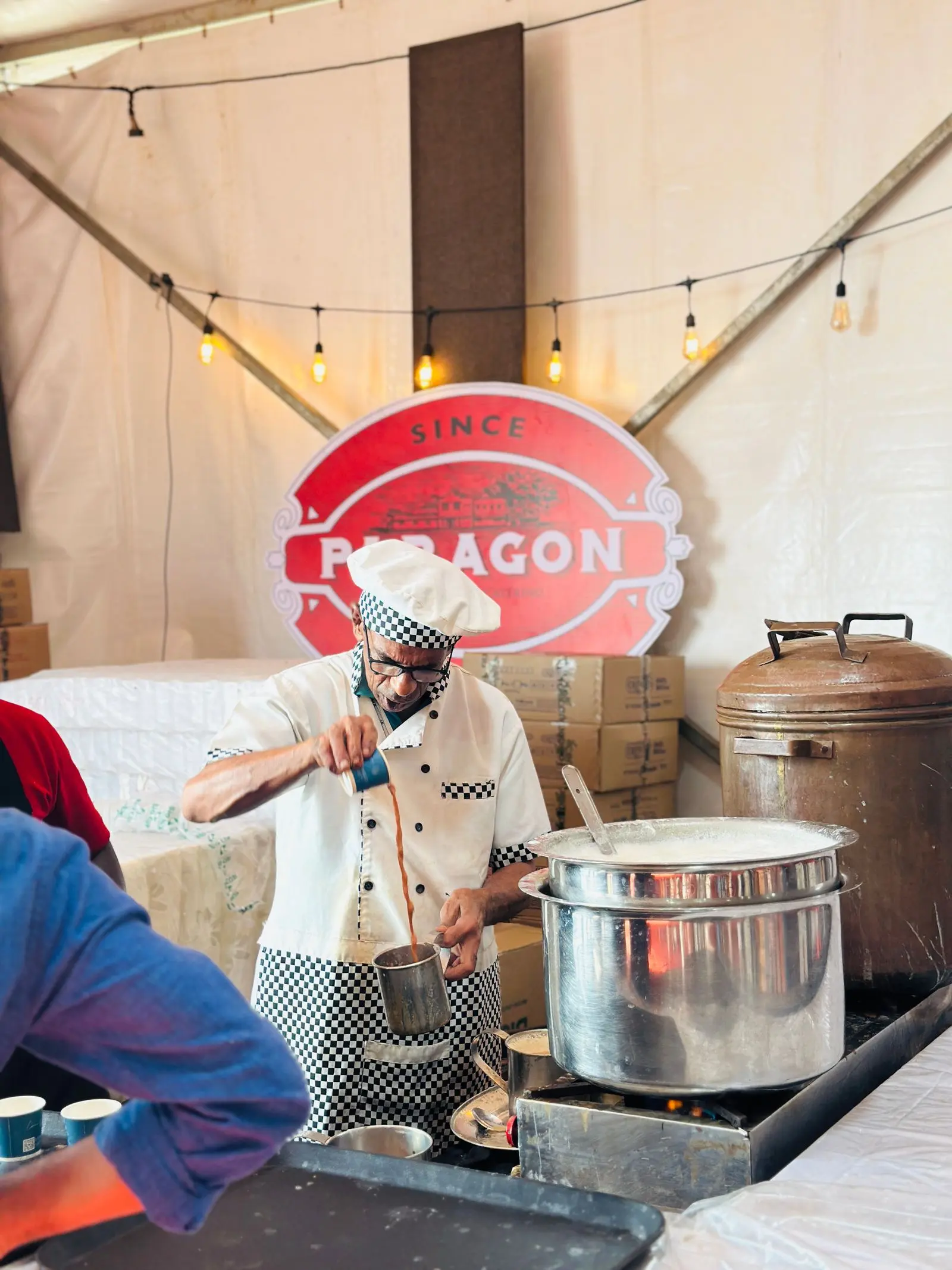 Chef preparing food at a lively market event