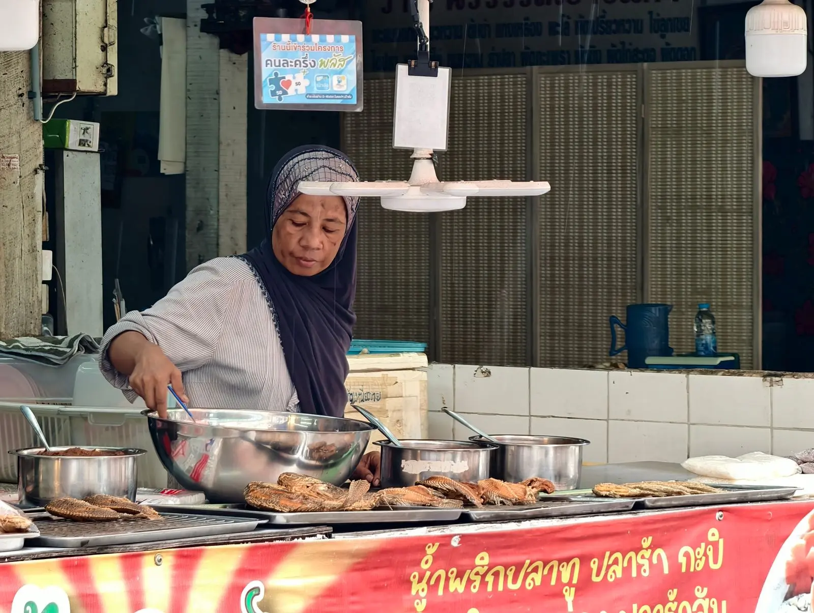 Thai street food vendor cooking at an open market