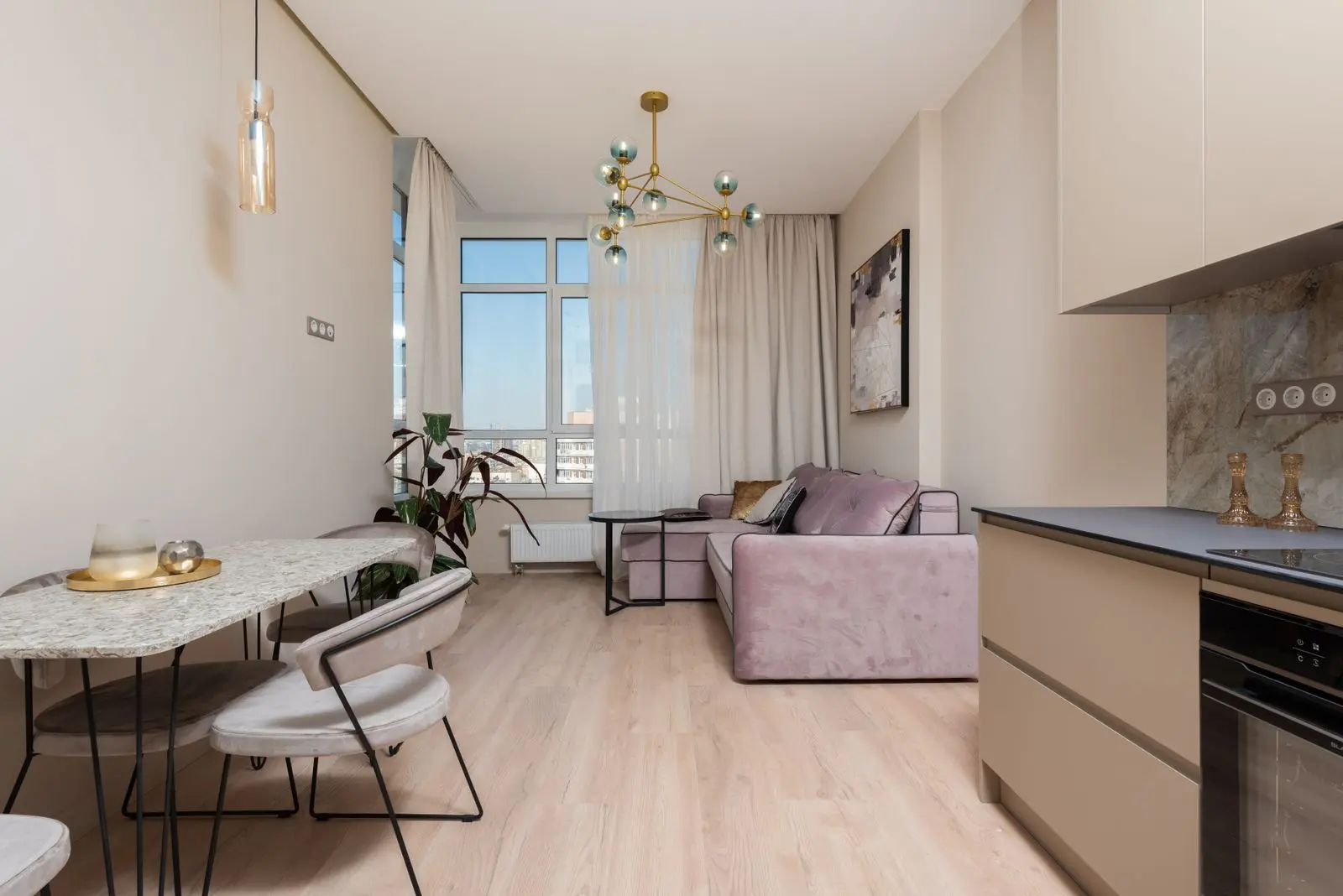 Bright furnished apartment interior with an open kitchen