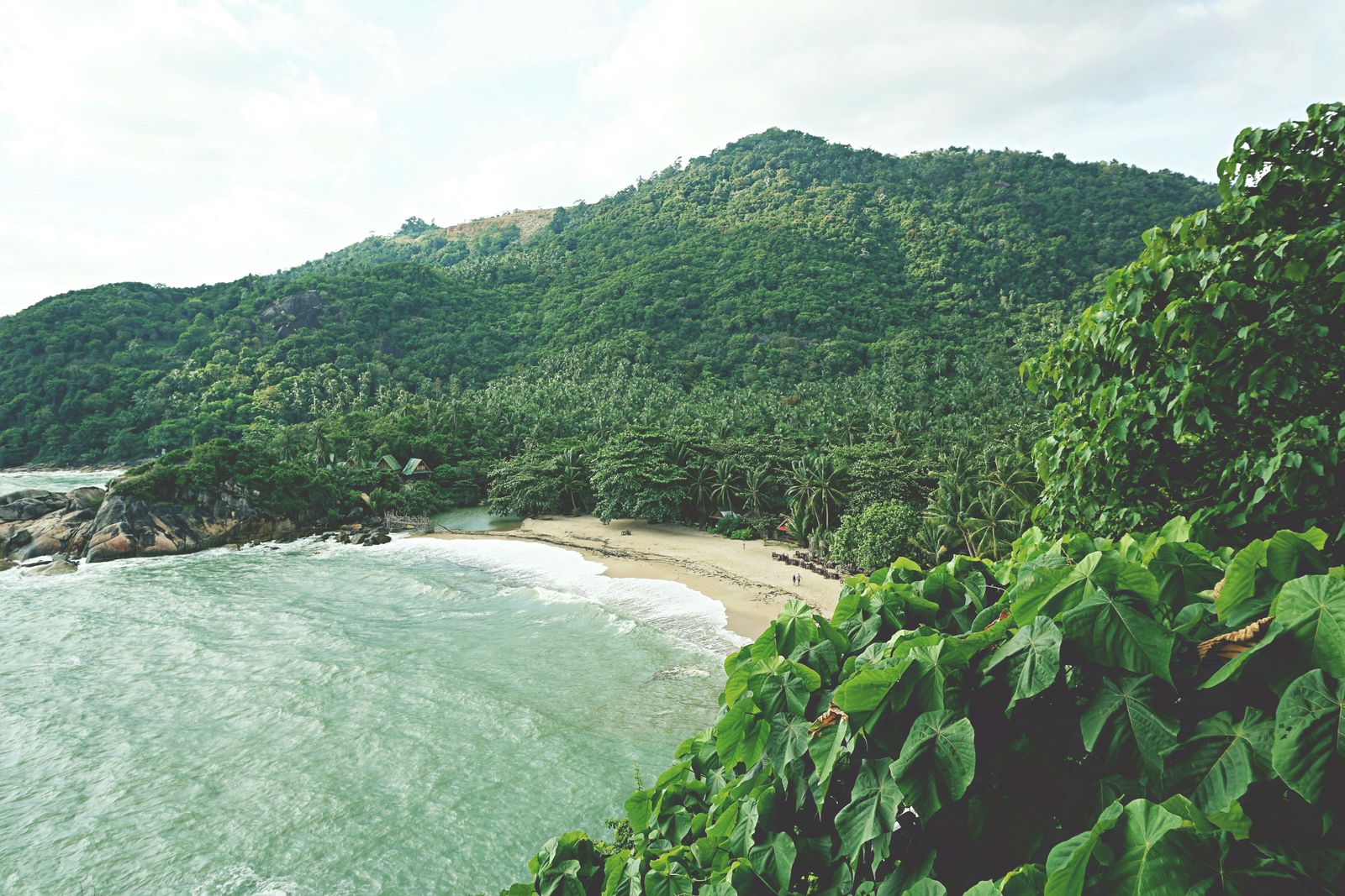 Tropical beach and green hills on Koh Phangan