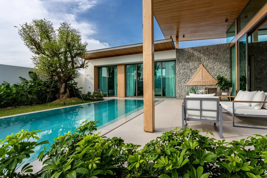 Private pool framed by garden planting and the B1 show villa