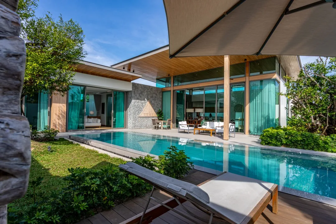 Wide view of the B1 show villa's private pool, terrace and garden